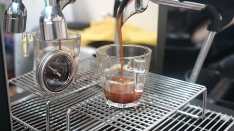 Professional espresso machine pouring strong looking fresh coffee into a glass Stock Footage 236452619
