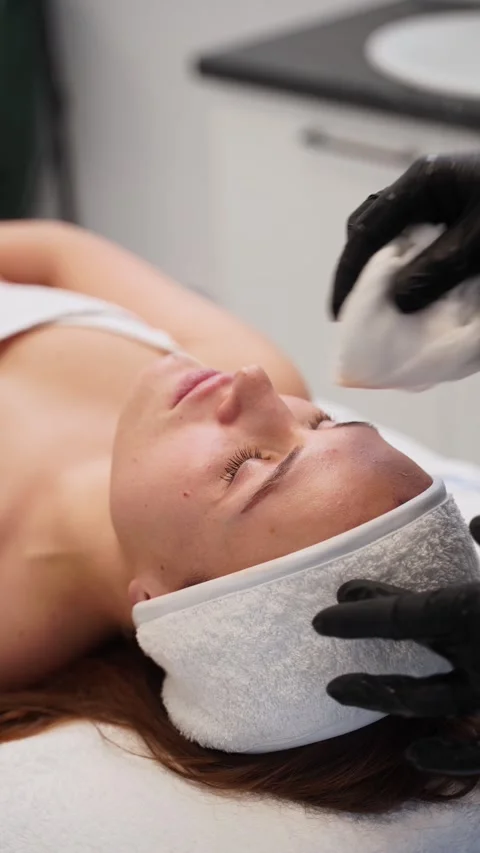 Professional esthetician performs deep cleansing facial massage on relaxed woman Stock Footage 261372387