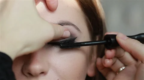Professional eye make-up: mascara application. Straight look at camera. Close-up Stock Footage 52993532