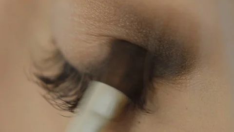 Professional Eye makeup artist applying eyeshadow powder. Beautiful woman face Stock Footage