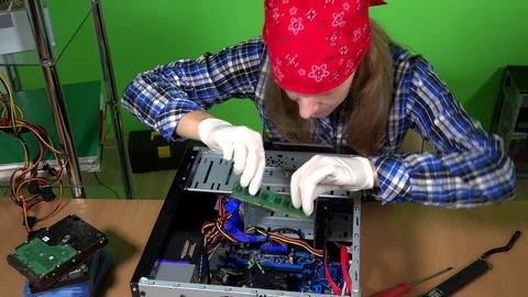 Professional female computer repairer installing ram memory to desktop pc Stock Footage 95692944
