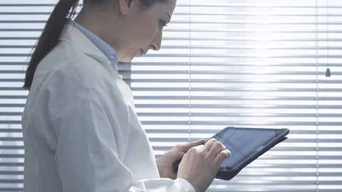 Professional female doctor using a digital tablet Stock Footage 117922294