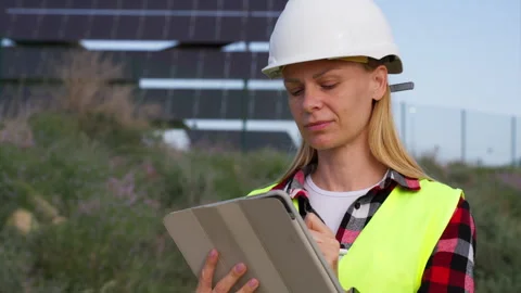 Professional female engineer in hard hat and safety vest working with table.. Stock Footage 333581266
