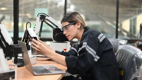 Professional female engineer technician working with robot maintenance Stock Footage 241523627