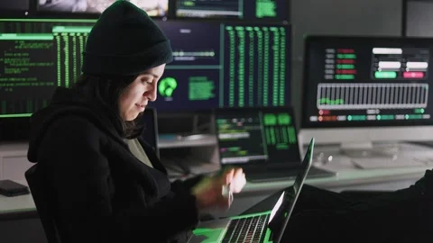 Professional female hacker typing virus code on laptop for cyber attack Stock Footage 310505614