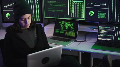 Professional female hacker typing virus code on laptop for cyber attack Stock Footage 310505765