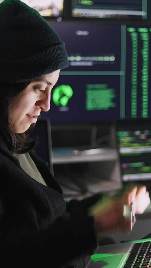 Professional female hacker typing virus code on laptop for cyber attack Stock Footage 316849798