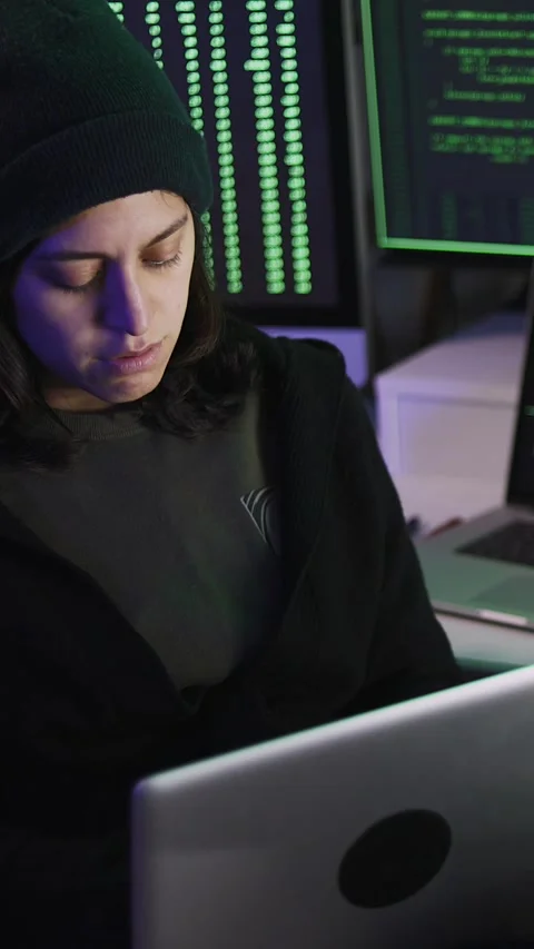 Professional female hacker typing virus code on laptop for cyber attack Stock Footage 316850025