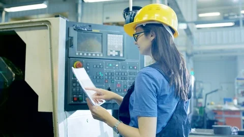 Professional Female Operator in Hard Hat Setting up/ Programming CNC Machine  Stock Footage 77530273