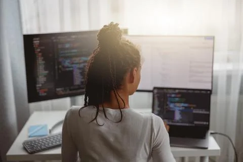 Professional female programmer working on new project on computer at home, back 스톡 사진