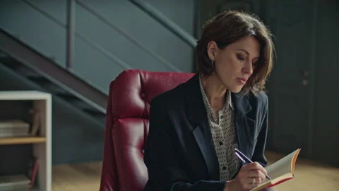 Professional Female Psychologist Taking Notes on Therapy Session with Client Stock Footage 317734264