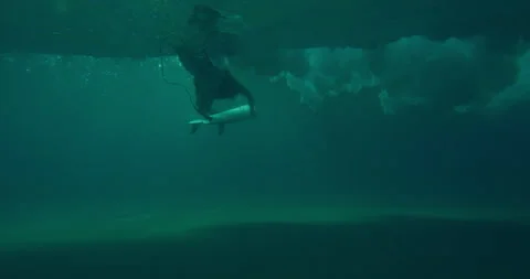 Professional female surfer diving under large ocean wave with surfboard in Austr Stock Footage 199462607