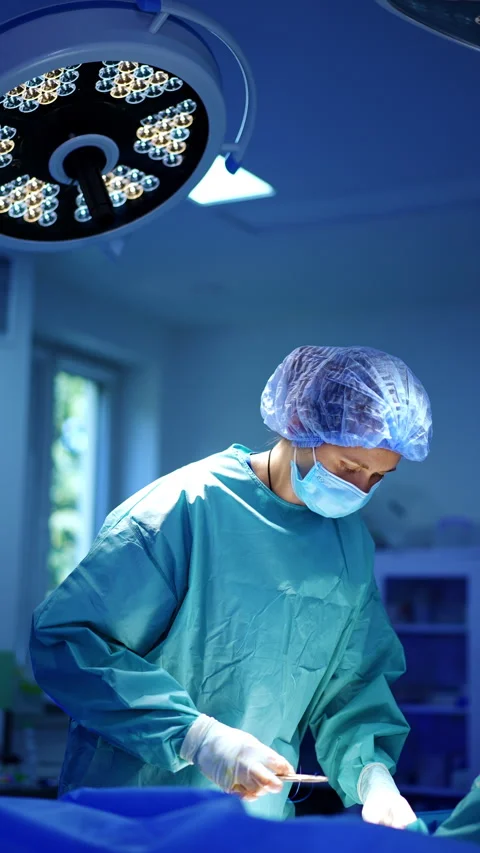 Professional female surgeon uses forceps to fasten the needle  Stock Footage 297298525