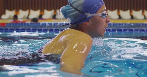 Professional female swimmer in goggles on swimming pool Stock Footage