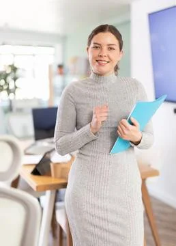 Professional female worker with a folder of documents in hands is meeting new 写真素材