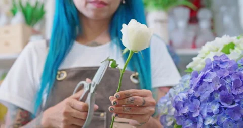 Professional florist hands closeup, cuts rose for bouquet in flower shop.  Stock Footage 201018779