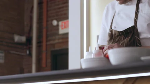 Professional focused chef preparing a finished dish in interior kitchen with sof Stock Footage 199458798
