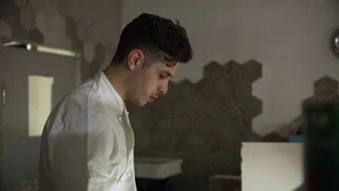 Professional focused pizza chef preparing a pizza and putting mozzarella cheese Stock Footage 199459631