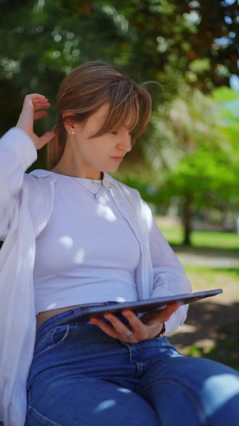 Professional freelancer working remotely on tablet, sitting on park bench Stock Footage 308387879
