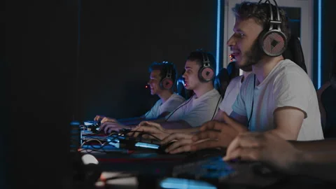 Professional gamers are playing computer game on PC at cyber club. Cyber team is Stock Footage 291773124