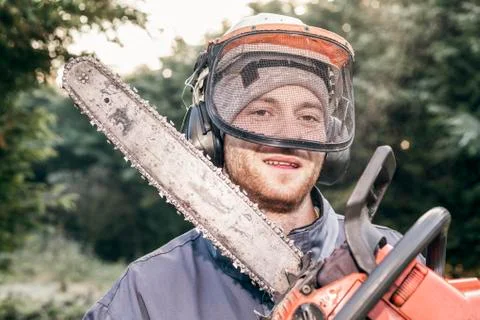 Professional gardener with chainsaw Stock Photos