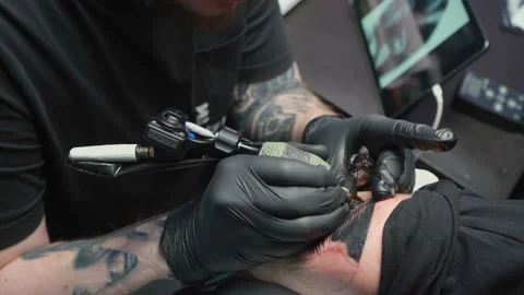Professional getting tattoo of snake in studio Stock Footage 124253596