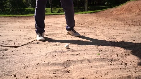 Professional golfer hitting his ball out of a bunker with the sand. Video stock 238049974