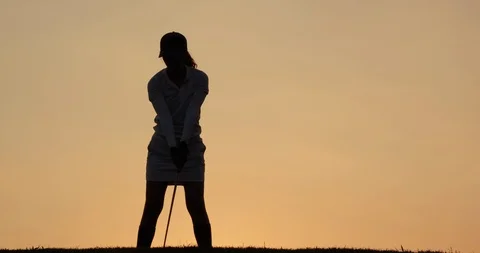 Professional golfer playing golf course with sunset background. Stock Footage