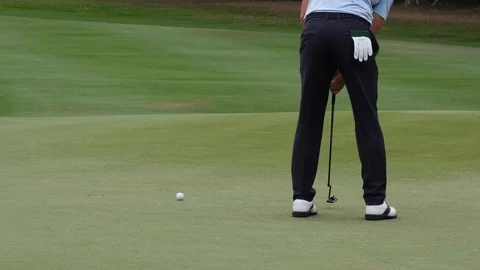 Professional golfer putting golf ball to hole on green golf course on hills. Stock Footage 122968137