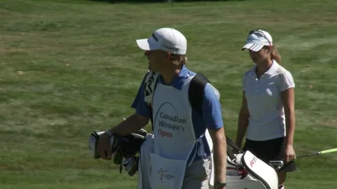 Professional golfers walking on golf course. 動画素材 76780712