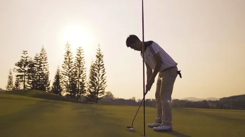 Professional Golfing walking go to Putting with putter hit the golf ball Stock Footage 123067879