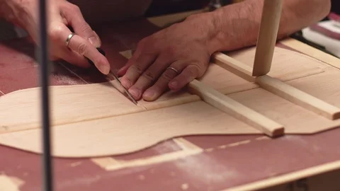 Professional guitar maker makes space for structure braces Stockbeeldmateriaal 117974681
