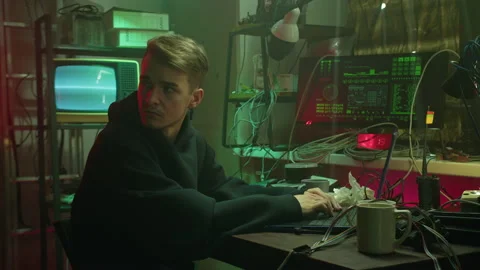 Professional hacker typing on keyboard at night, trying to break password, using Stock Footage 163681957