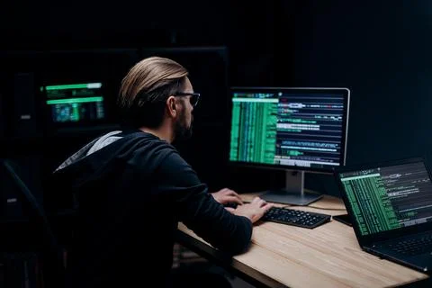 Professional hacker working on computer Stock Photos