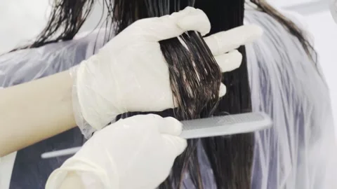 Professional hair coloring process in salon, horizontal close-up Stock Footage 345136199