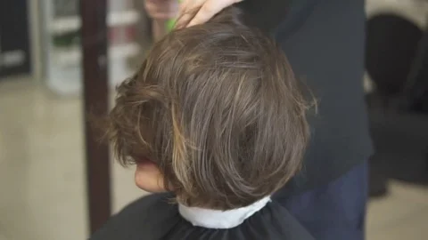 Professional Hair Dresser using a hairdryer after haircut. Young woman in beauty Stock Footage