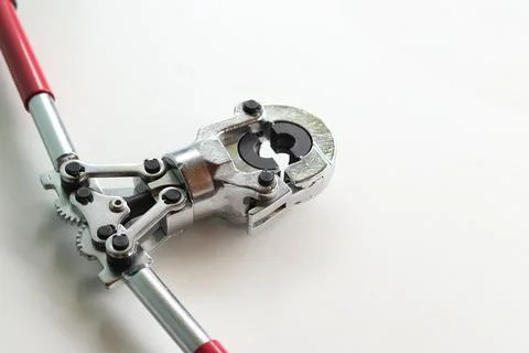 Professional hand-held pipe crimping pliers on a white background Stock Photos