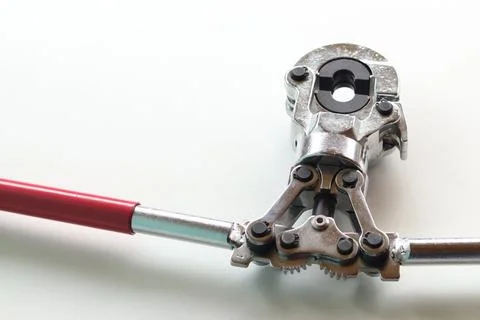 Professional hand-held pipe crimping pliers on a white background Stock Photos