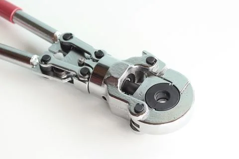 Professional hand-held pipe crimping pliers on a white background Stock Photos