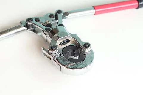 Professional hand-held pipe crimping pliers on a white background Stock Photos