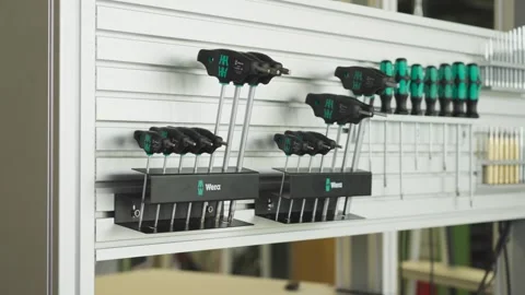 Professional hand tools neatly arranged on a workshop storage wall in Germany Stock Footage 345021679