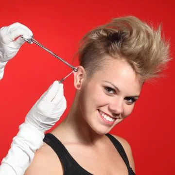 Professional hands making a piercing hole to a fashion woman Stock Photos