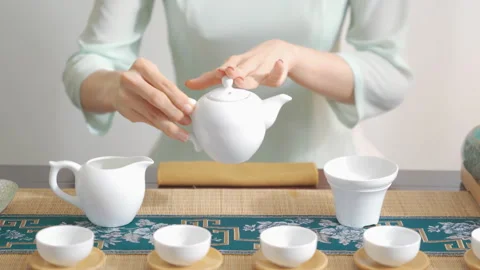 Professional hands of tea master prepare traditional ceremony chahe with black Stockbeeldmateriaal 333375290