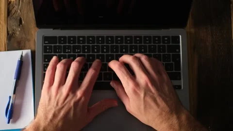 Professional Hands Typing Rapidly on a Laptop Stock Footage 332686687