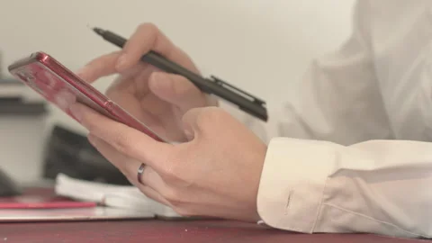Professional Hands Using Smartphone and Writing Notes at Desk Vídeos de archivo 334858587