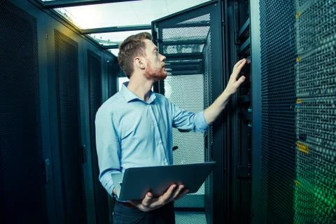 Professional handsome technician checking the wire system Stock Photos