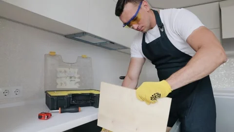 Professional handyman doing assembly kitchen furniture set installation well Stock Footage 130452542
