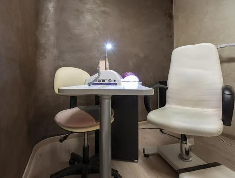 Professional hardware manicure using electric machine in beauty salon. Stock Photos