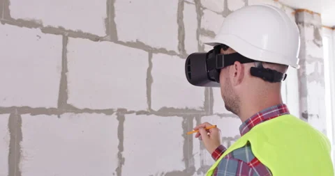 Professional with headset holds pencil performing calculations Video stock 309930265