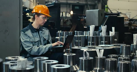 A professional heavy industry engineer in a protective uniform and hard hat uses Stock Footage 200913414